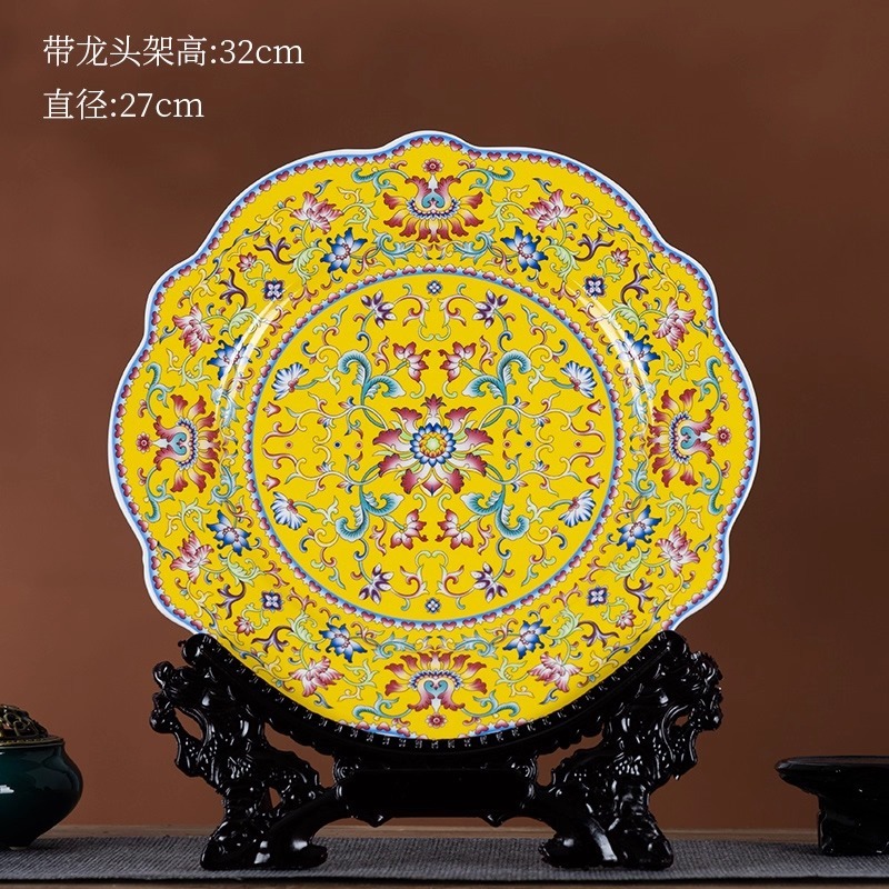 Yellow enamel ceramic display plate with auspicious lotus pattern on a dragon-head wooden stand