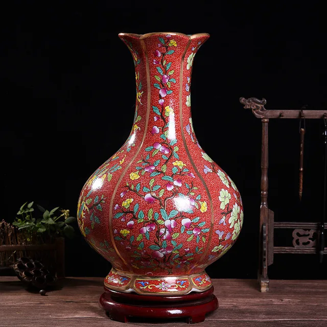 The pictured red-ground vase has a rounded body, flared mouth and colorful flowers across its surface