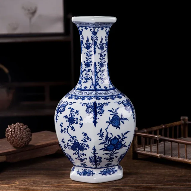 Blue floral motifs cover the white body and long neck of the pictured vase