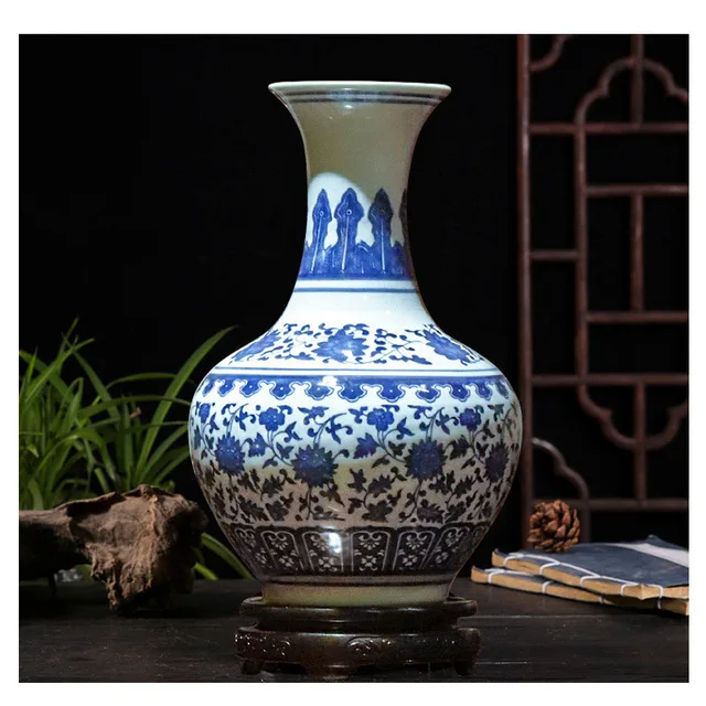 The pictured rounded vase has blue lotus decoration on a white ground below a long, flared neck
