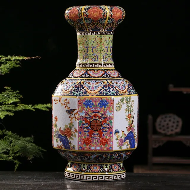 An octagonal vase has a rolled rim and densely patterned borders framing multicolor floral panels