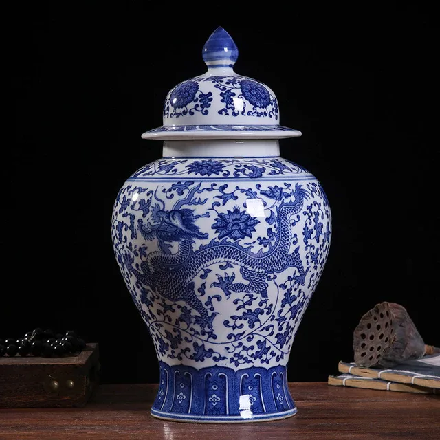 A blue-and-white jar pairs a rounded dragon-patterned body with a tiered lid and pointed finial