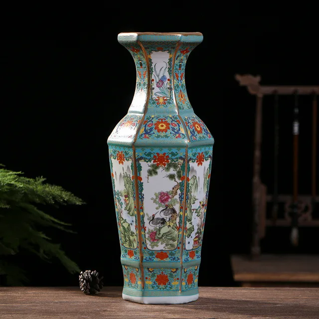 Floral and bird panels decorate the flat faces of the pictured vase within turquoise borders