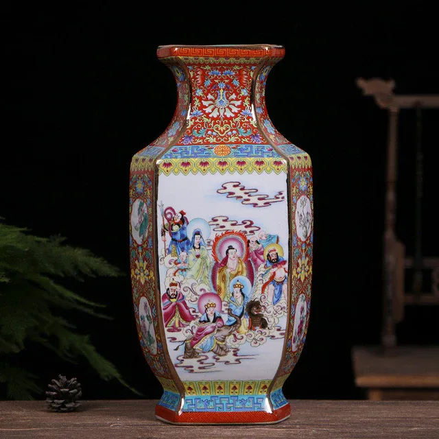 A hexagonal vase features scenes of figures in white panels framed by red and blue decoration