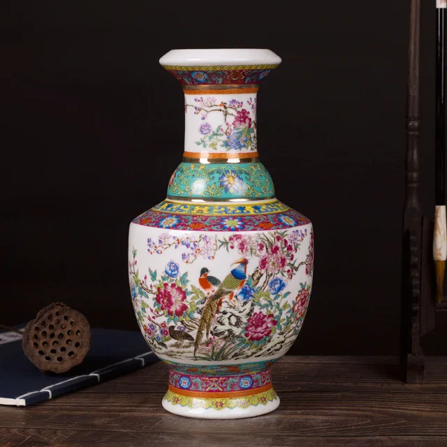 The pictured vase combines floral and bird decoration with green and patterned borders
