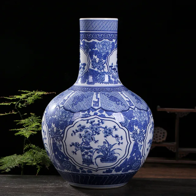 A blue-and-white vase has a rounded body with floral panels and a straight cylindrical neck