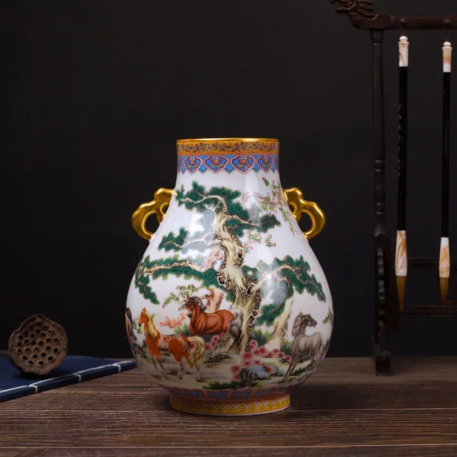 The pictured vase has a rounded body with an animal landscape and two gold-tone handles