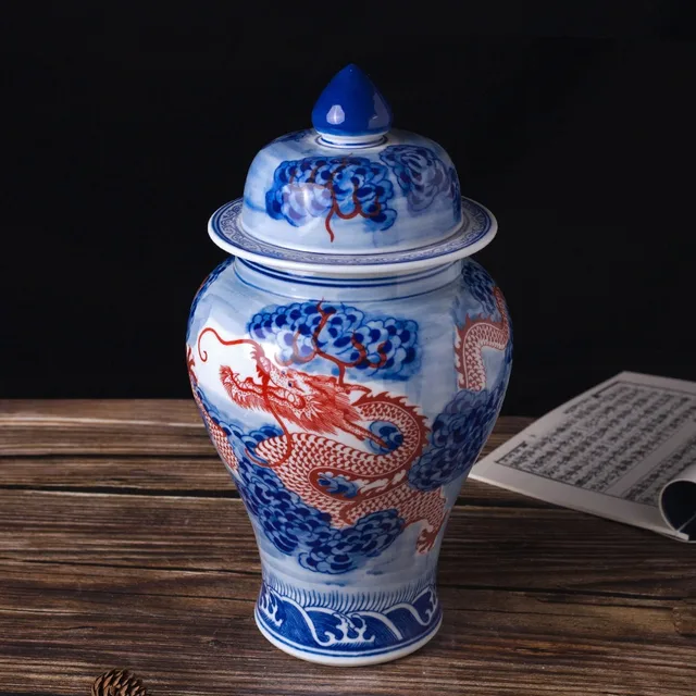 The pictured lidded jar combines a red dragon with blue-and-white borders and a pointed lid finial